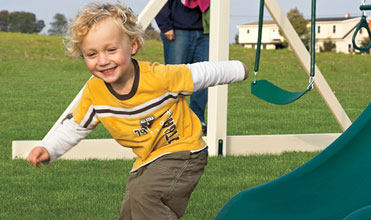 child getting low-impact exercise on swing set child getting low-impact exercise on swing set