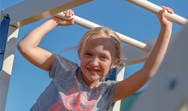girl with enhanced motor skills on monkey bars girl with enhanced motor skills on monkey bars