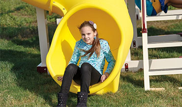 child on an adventure world playset in her backyard child on an adventure world playset in her backyard