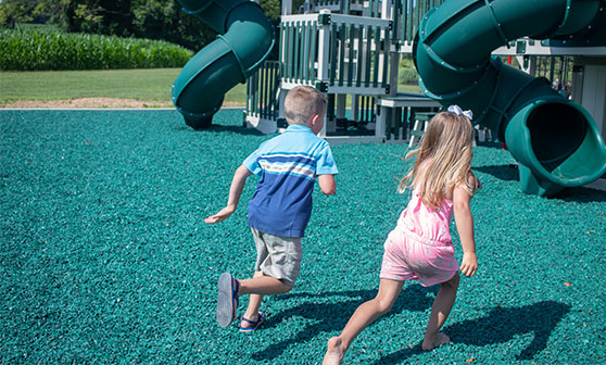 boy and girl playing on a premium playset premium playsets