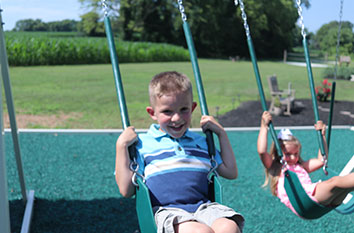 boy using swing set for exercise swing set exercise