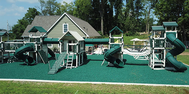 custom home swing set with eight slides, five towers, trapeze rings, a sandbox, and a lemonade stand huge custom home swing set