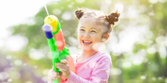 girl outside playing super soaker swing set game swing set games