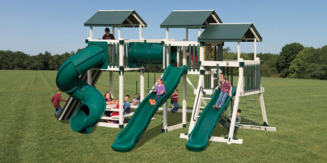 good time tower jungle gym with three towers, three slides, extra tall rock wall, and a chain ladder good time tower jungle gym